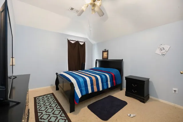 a bedroom with bed and window