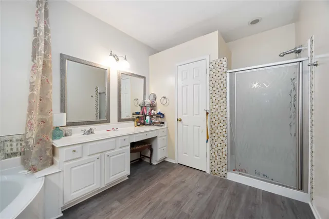 a bathroom with a double vanity sink mirror and shower
