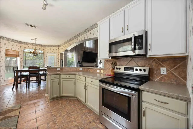 a kitchen with stainless steel appliances a stove microwave and cabinets