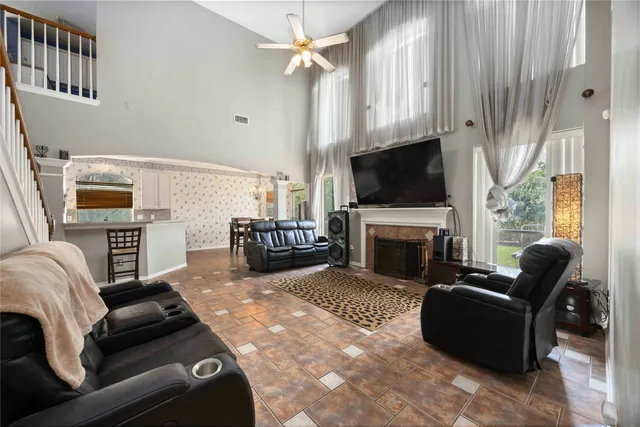 a living room with furniture a fireplace and a flat screen tv