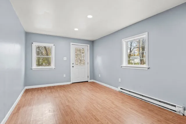 a view of an empty room with wooden floor