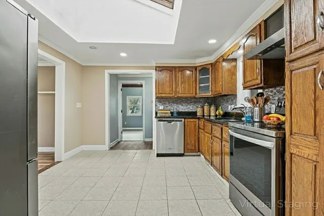 a view of an empty room with a fireplace and a window