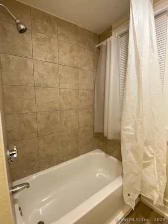 a bathroom with a bathtub and shower