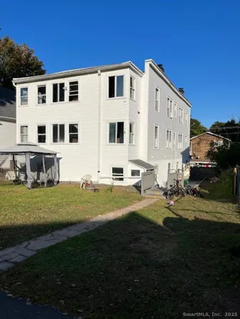a view of a house with backyard and sitting area