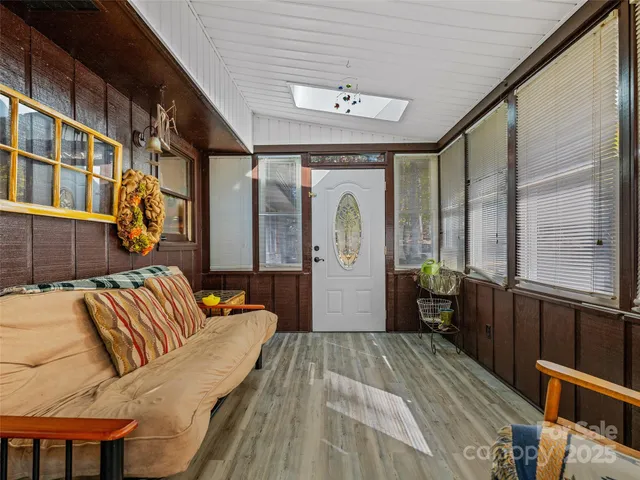 a bedroom with furniture and a large window