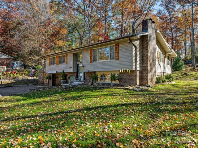 a front view of a house with a yard table and chairs