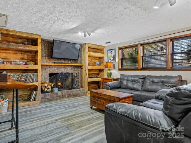 a living room with furniture fireplace and flat screen tv