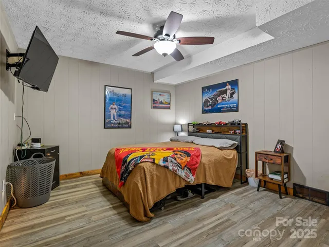 a bedroom with a bed and a chandelier