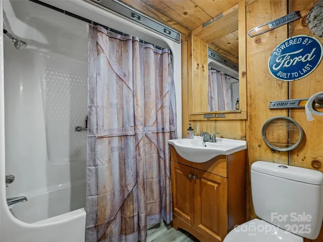 a bathroom with a granite countertop toilet sink and mirror
