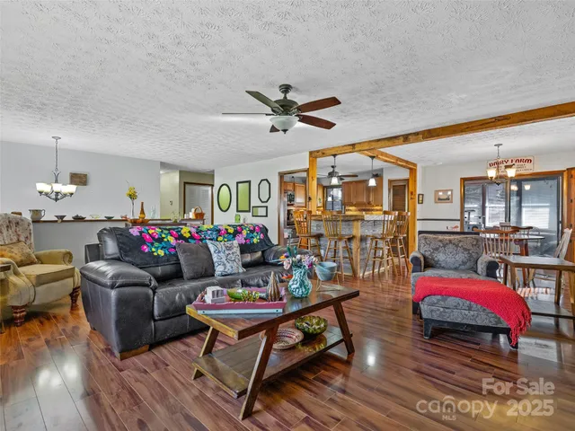 a living room with furniture a rug and a chandelier