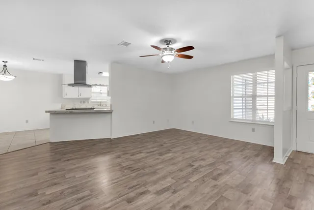 wooden floor in an empty room with a window