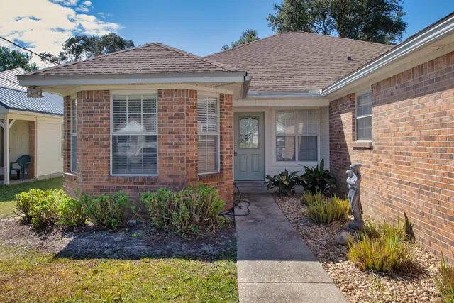 a view of a brick house with plants