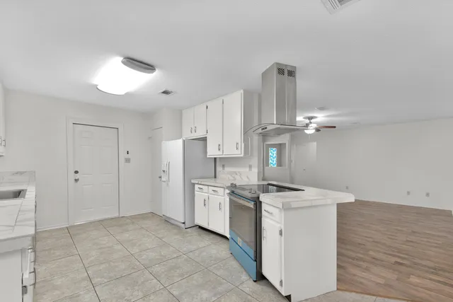 a kitchen with stainless steel appliances granite countertop a stove and a refrigerator