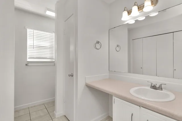 a bathroom with a sink a mirror and a shower