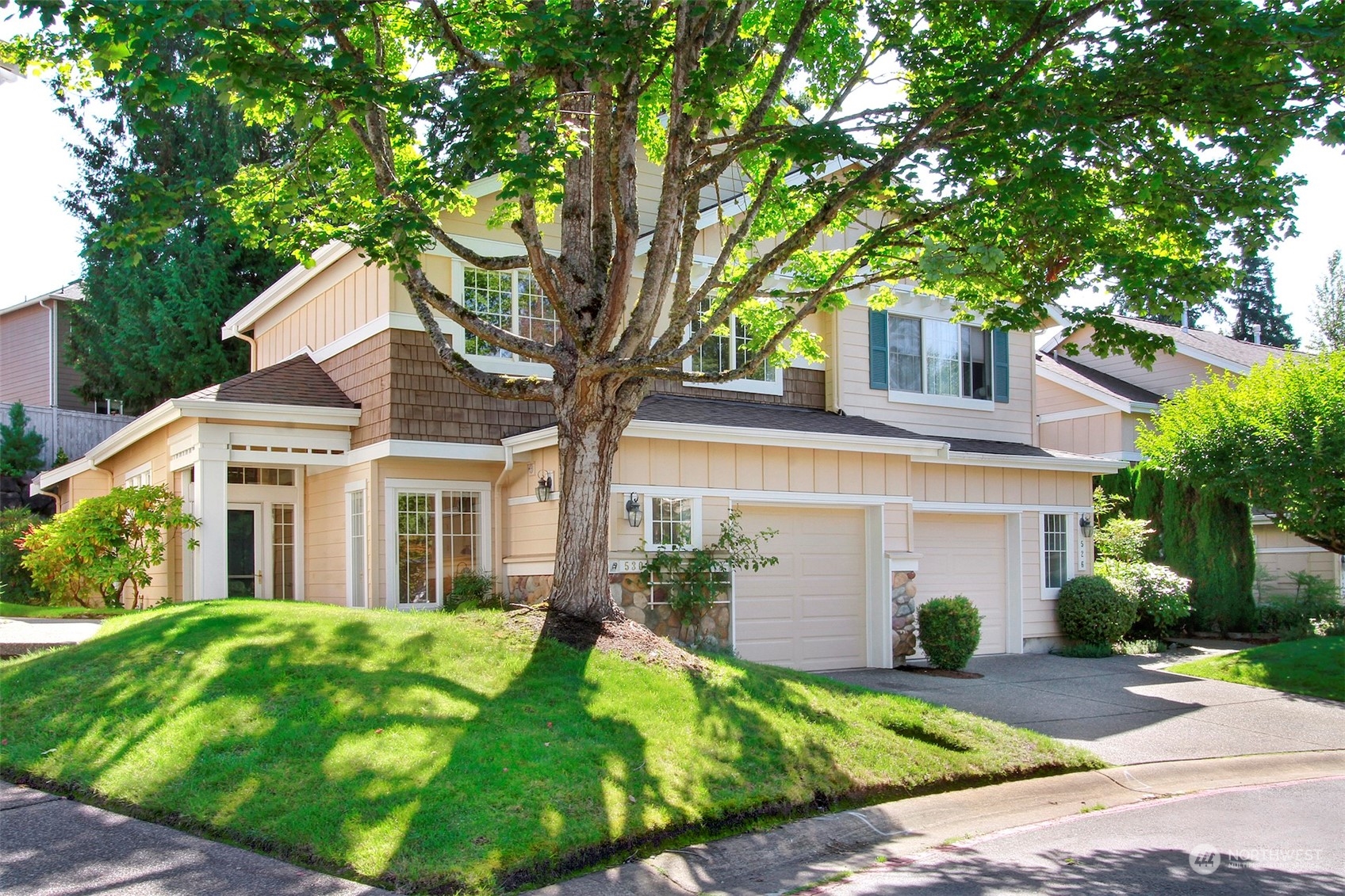530 Elma Place Northeast Renton, WA 98059 - Photo 1 of 32 a front view of a house with a garden and trees
