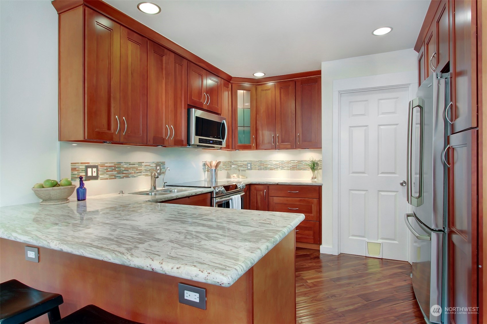 530 Elma Place Northeast Renton, WA 98059 - Photo 12 of 32 a kitchen with stainless steel appliances granite countertop a refrigerator a stove top oven a sink and dishwasher