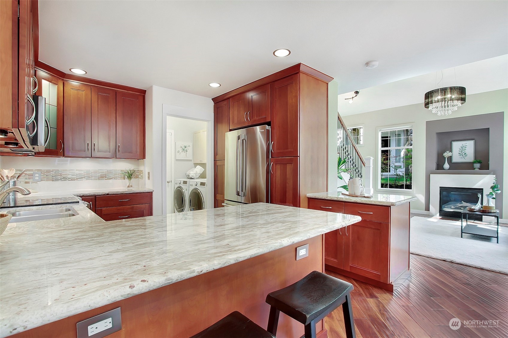 530 Elma Place Northeast Renton, WA 98059 - Photo 14 of 32 a kitchen with stainless steel appliances granite countertop wooden cabinets a stove a sink and a refrigerator