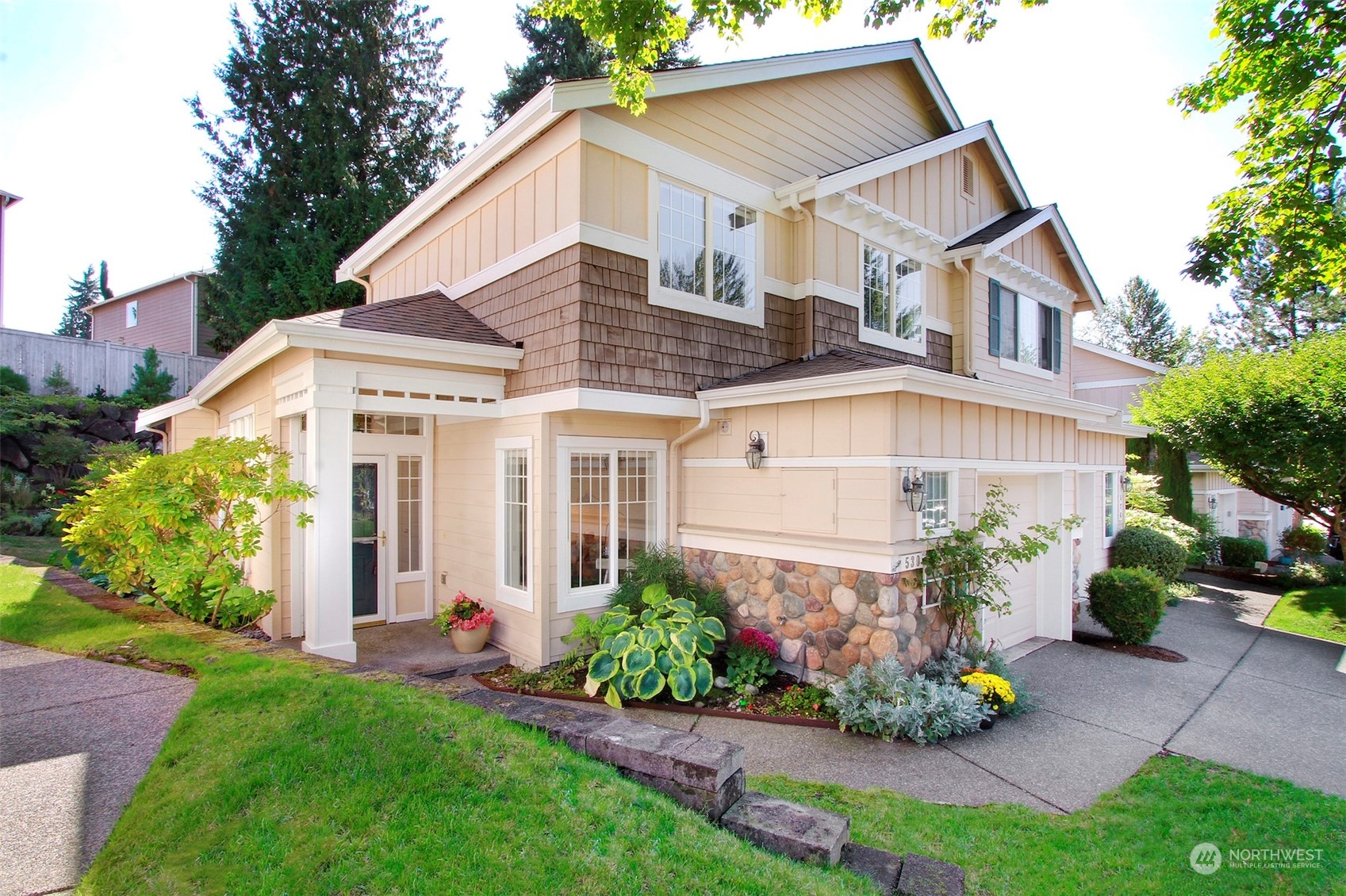 530 Elma Place Northeast Renton, WA 98059 - Photo 2 of 32 a view of a white house next to a yard and potted plants