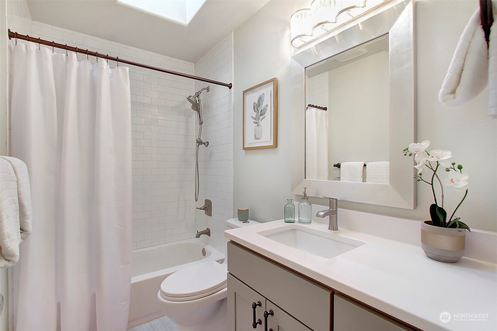530 Elma Place Northeast Renton, WA 98059 - Photo 26 of 32 a bathroom with a granite countertop sink a toilet and a mirror
