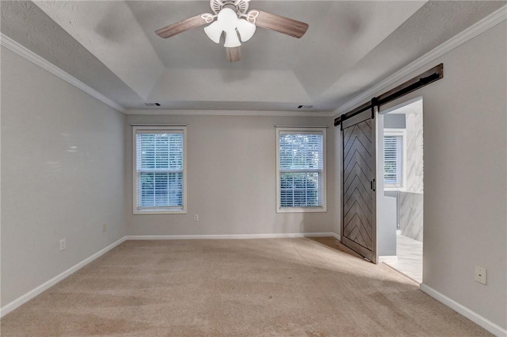 310 Andrew Ridge Drive Jefferson, GA 30549 - Photo 30 of 52 an empty room with chandelier fan and windows
