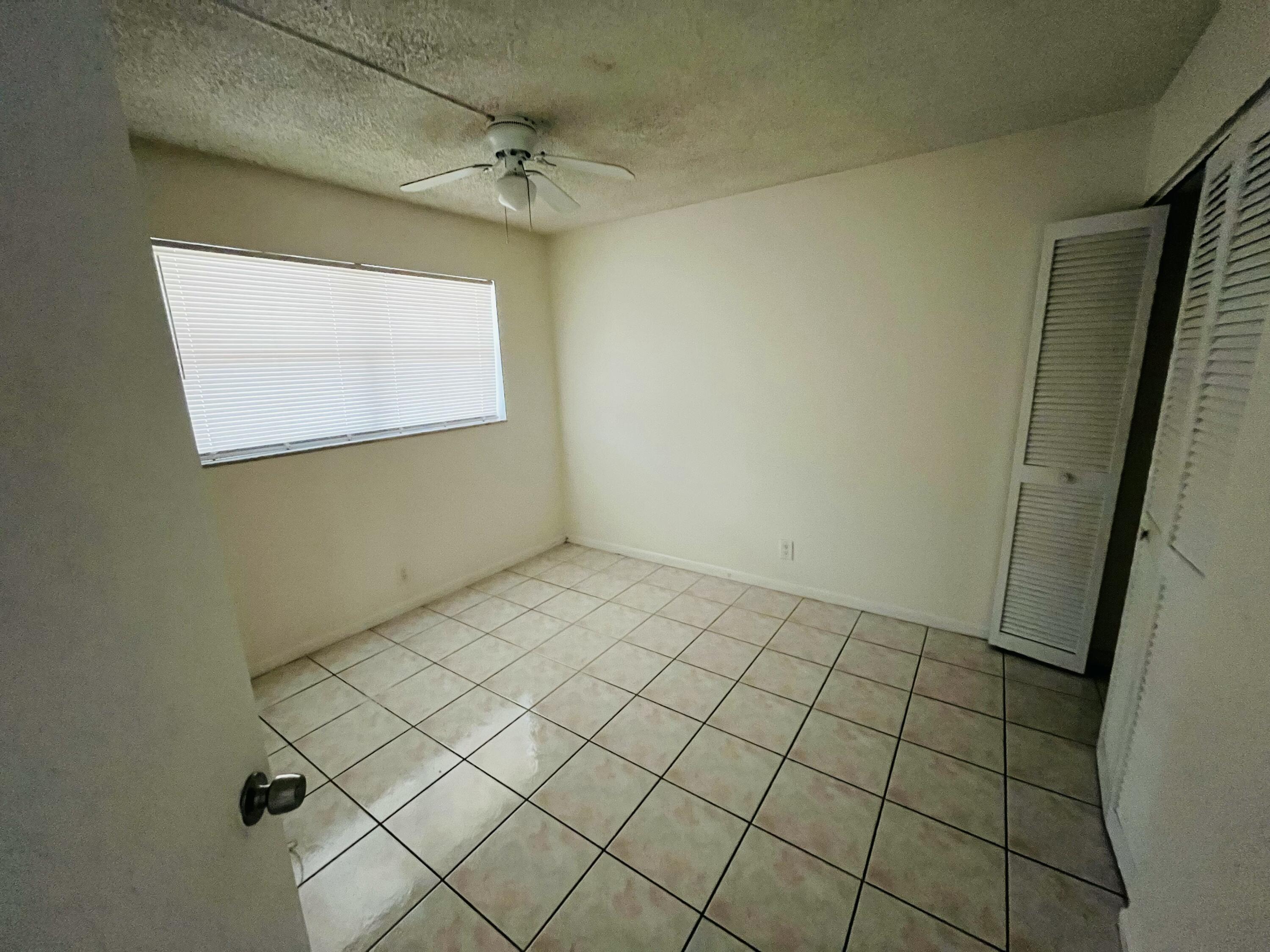 9911 Sandalfoot Boulevard, Unit 112 Boca Raton, FL 33428 - Photo 4 of 13 Guest Bedroom