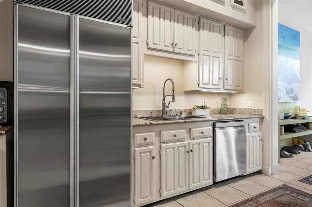 3424 Gillespie Street, Unit 5 Dallas, TX 75219 - Photo 13 of 31 a kitchen with granite countertop stainless steel appliances cabinets a sink and a window