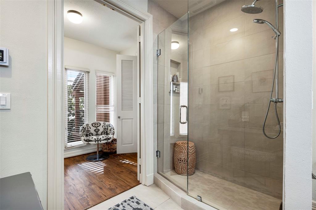 3424 Gillespie Street, Unit 5 Dallas, TX 75219 - Photo 25 of 31 a bathroom with a glass door shower and a sink