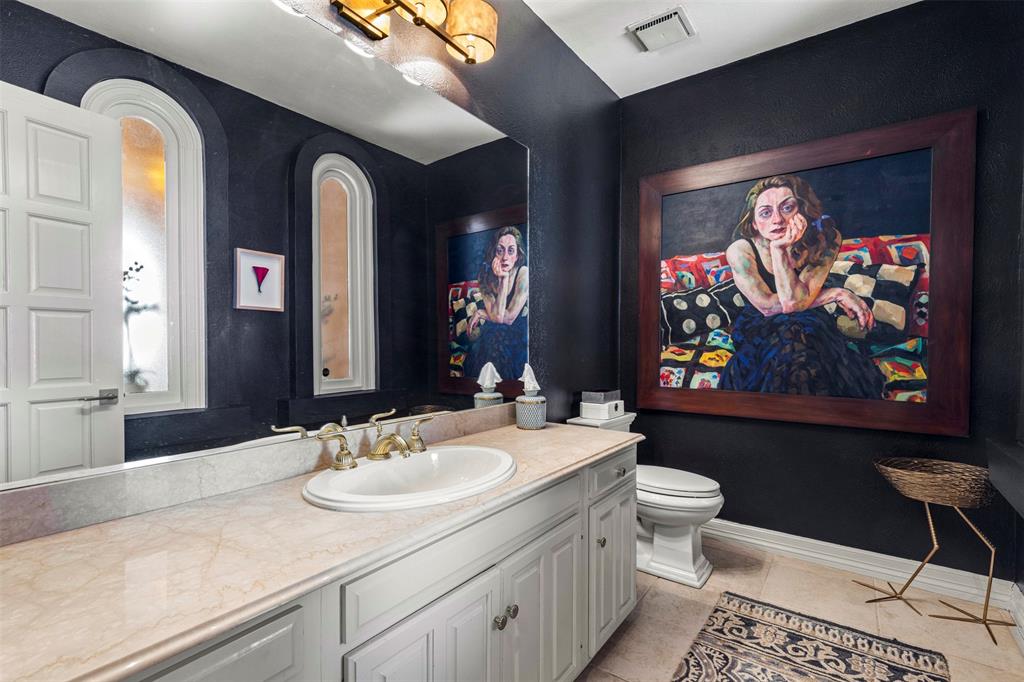 3424 Gillespie Street, Unit 5 Dallas, TX 75219 - Photo 29 of 31 a bathroom with a sink and a mirror