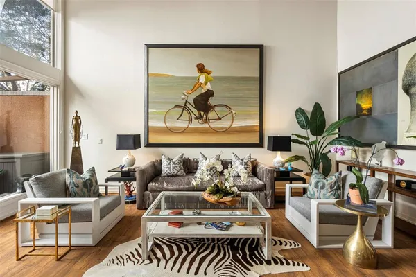 a living room with furniture a fireplace and a chandelier
