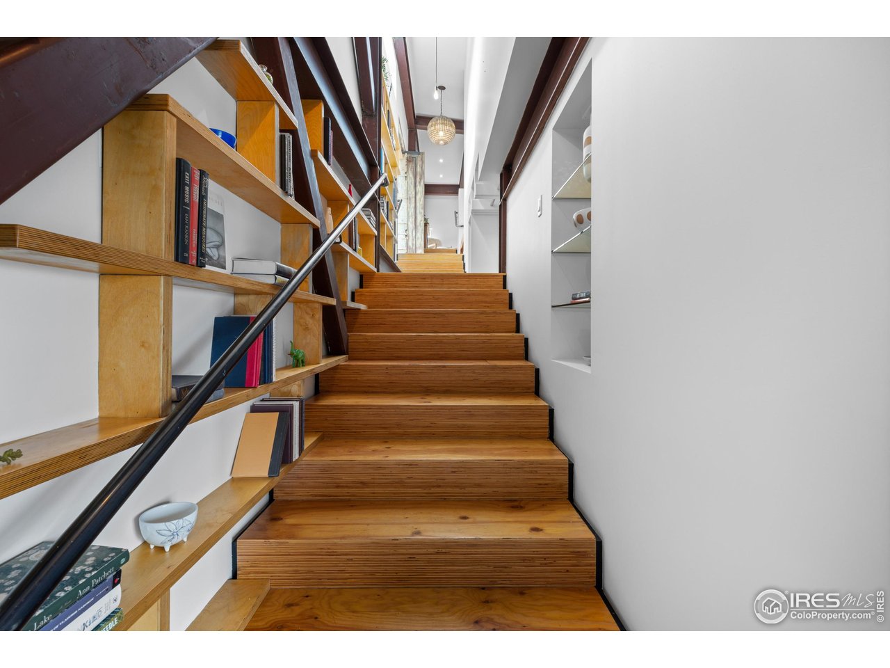 1440 Reed Ranch Road Boulder, CO 80302 - Photo 23 of 40 Stairwell connecting the foyer, upper, and main floor with beautiful built in shelving and exposed beams.