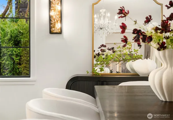 a living room with a couch and a potted plant