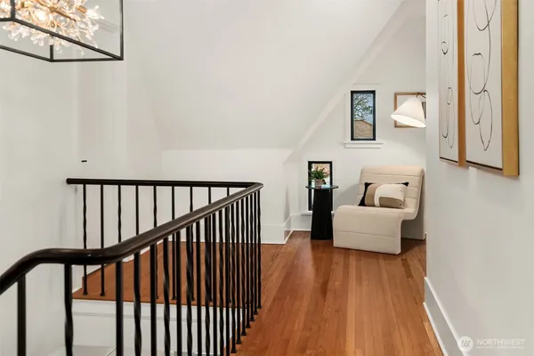 a bedroom with a large bed and wooden floor