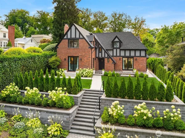 a front view of a house with a garden