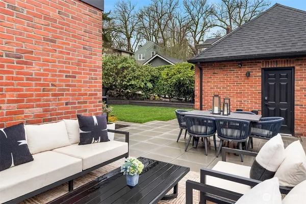 a backyard of a house with table and chairs