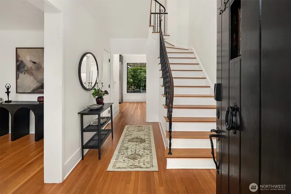a view of entryway and hall with wooden floor
