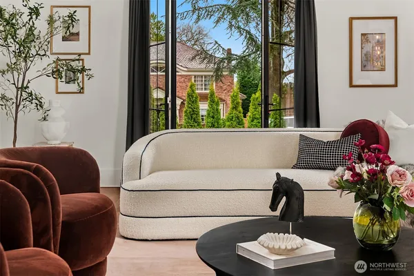 a living room with furniture flowerpot and window