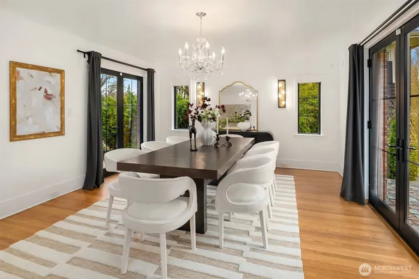 a view of a dining room with furniture wooden floor and chandelier