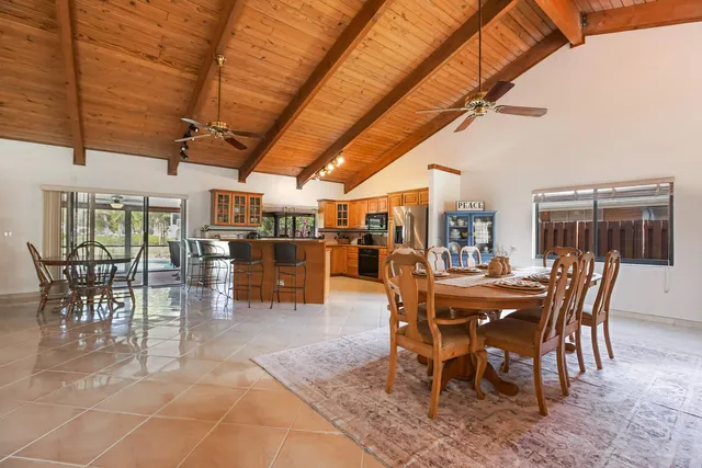 a dining room with furniture and a rug