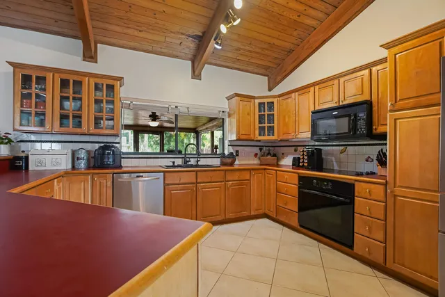 a kitchen with stainless steel appliances granite countertop a sink and cabinets
