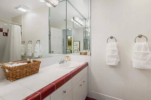 a bathroom with a double vanity sink and mirror