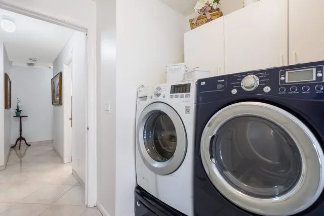 a view of a storage and utility room with washer and dryer