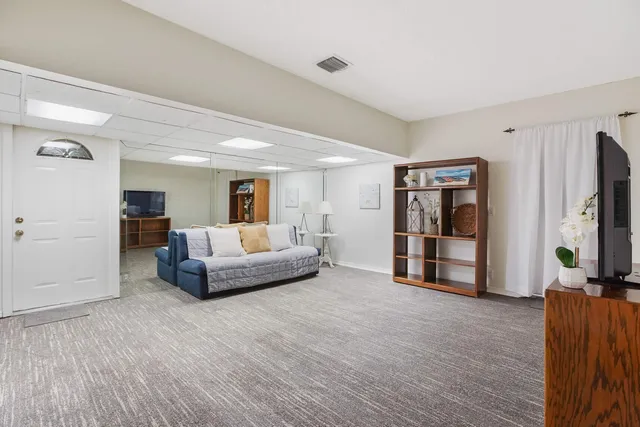 a bedroom with furniture and a flat screen tv