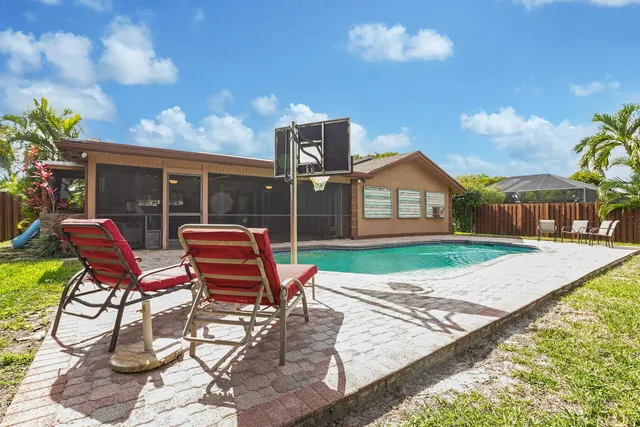 a backyard of a house with wooden floor yard and outdoor seating