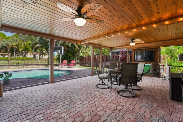 a view of a patio with table and chairs and wooden floor