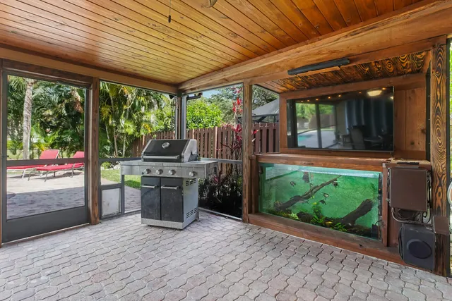 a view of a patio with table and chairs potted plants with wooden floor