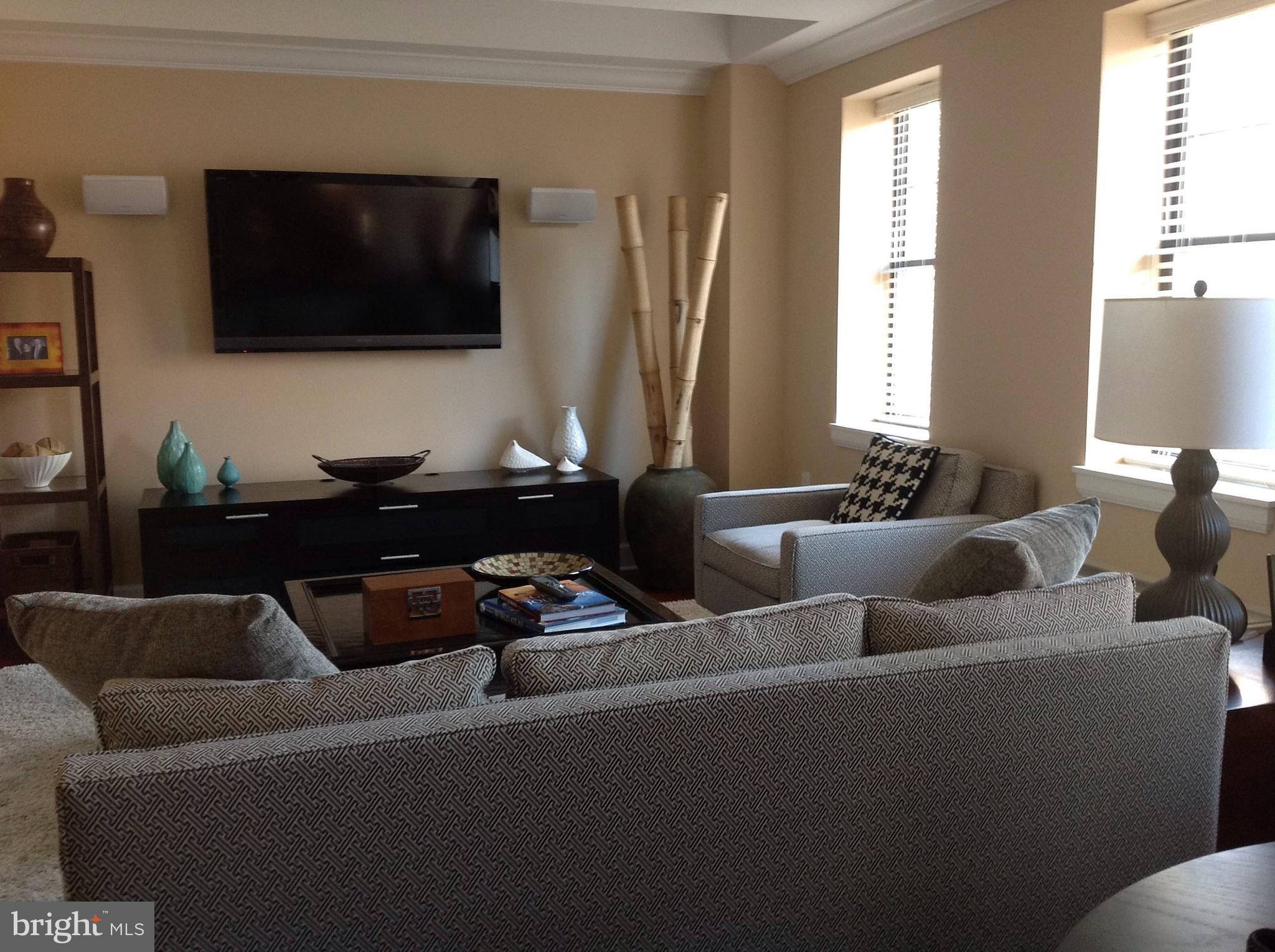 1701-15 Locust Street, Unit 1402 Philadelphia, PA 19103 - Photo 3 of 17 a living room with furniture and a flat screen tv