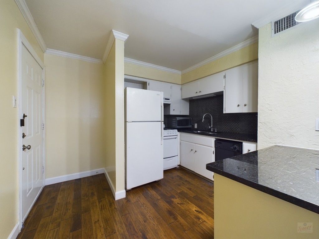 803 West 28th Street, Unit 206 Austin, TX 78705 - Photo 4 of 20 a kitchen with a refrigerator and a stove top oven