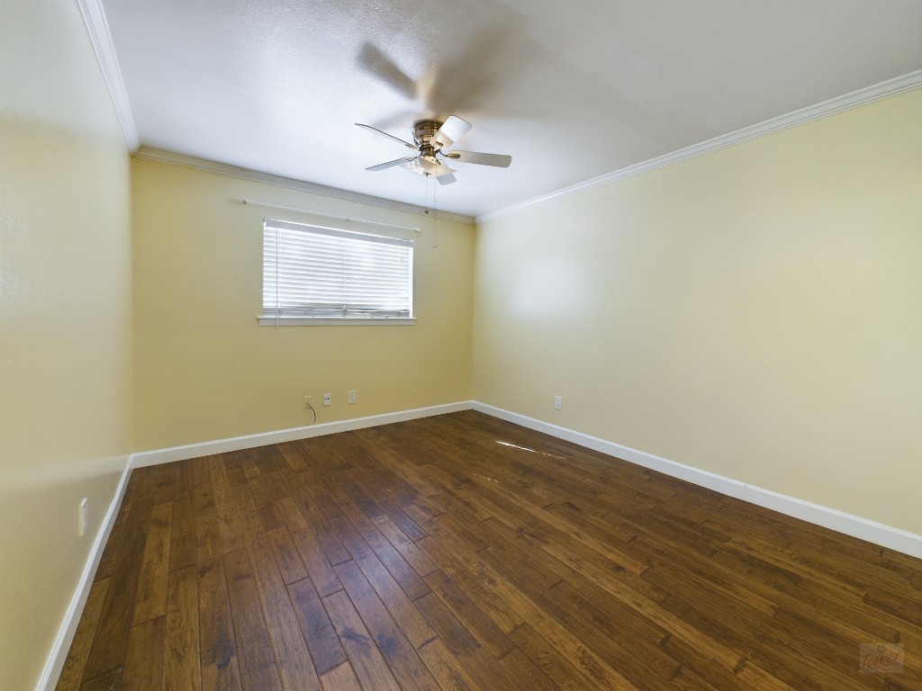 803 West 28th Street, Unit 206 Austin, TX 78705 - Photo 5 of 20 a view of an empty room with wooden floor and a window