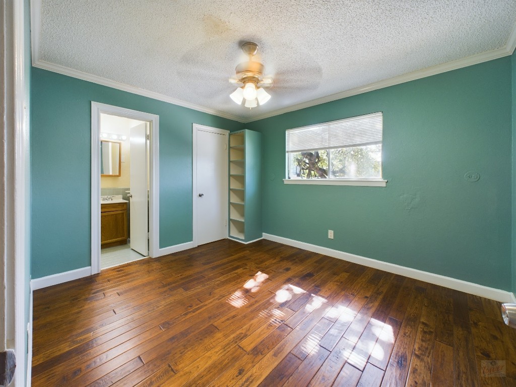 803 West 28th Street, Unit 206 Austin, TX 78705 - Photo 7 of 20 a view of an empty room with wooden floor and a window