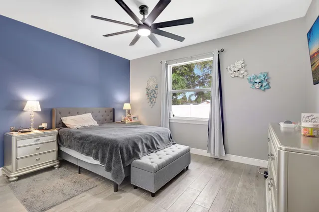 a bedroom with a large bed couch and a window